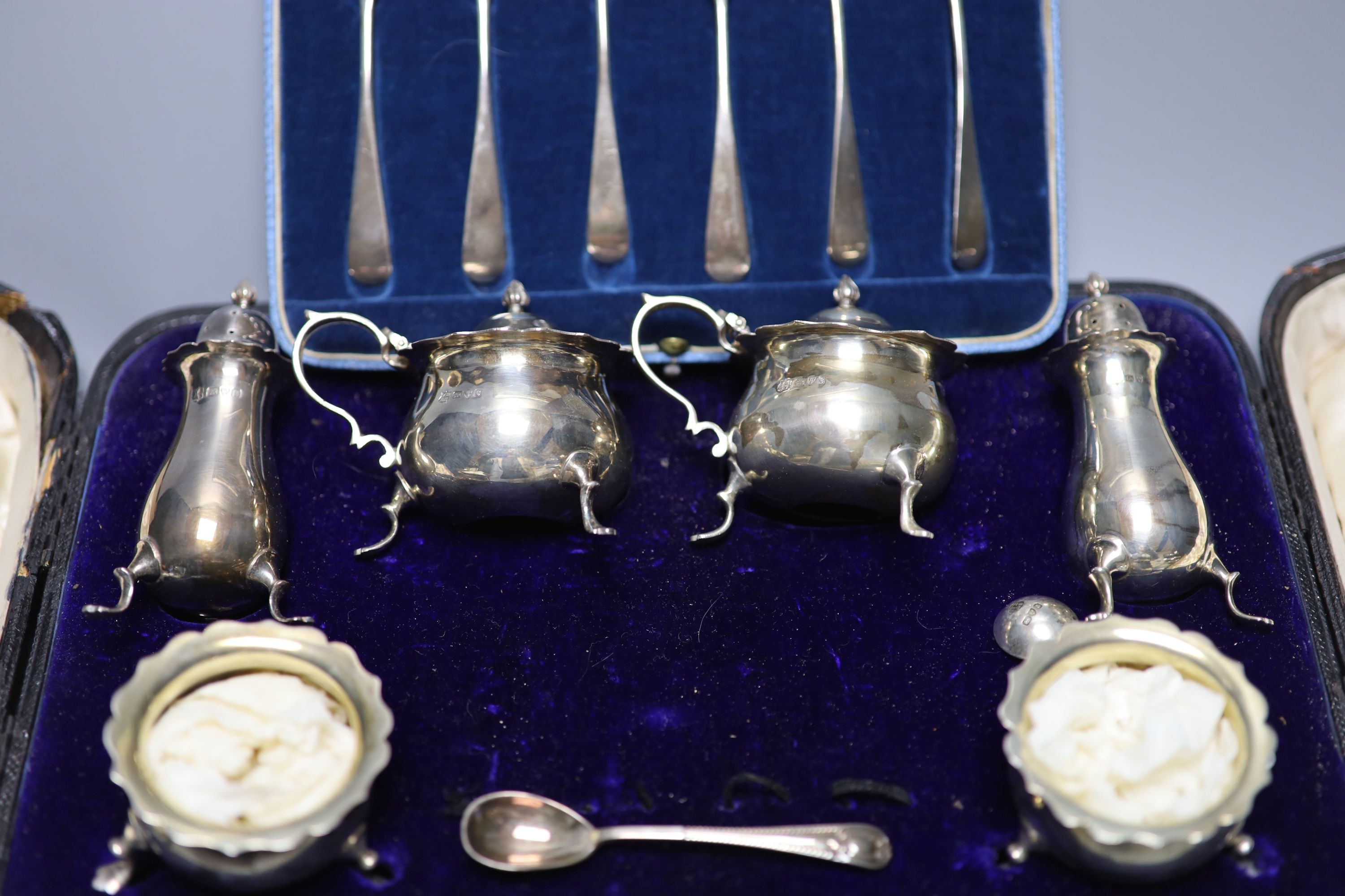 A cased set set of six 'British Hallmark' teaspoons and a cased part silver condiment set.